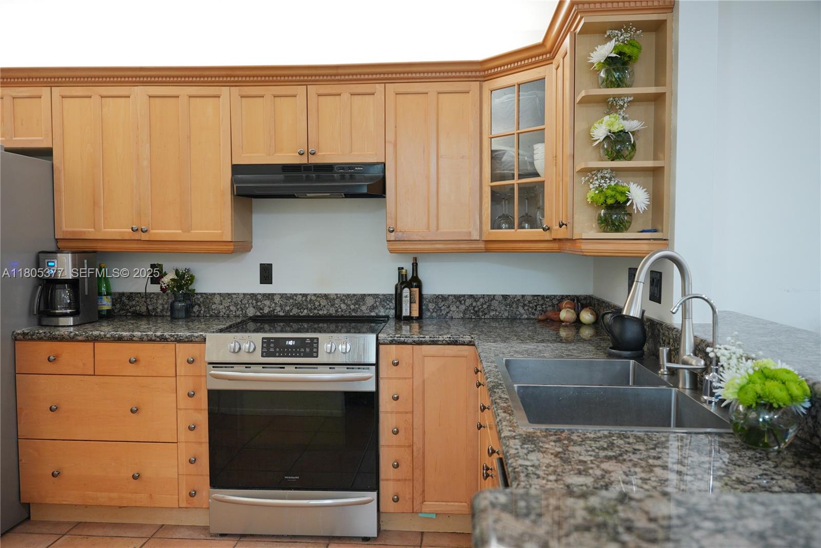 19663 Hampton Drive Boca Raton, FL 33434 - Photo 26 of 33 a kitchen with granite countertop a stove a sink and a microwave