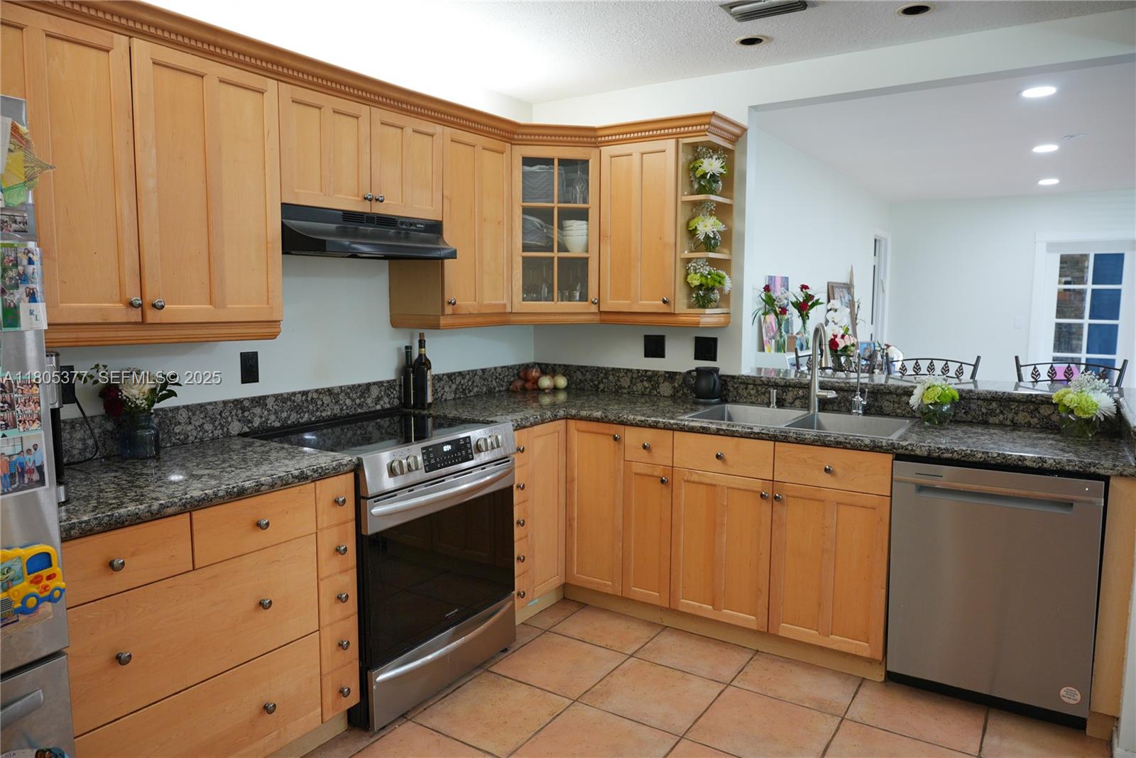 19663 Hampton Drive Boca Raton, FL 33434 - Photo 29 of 33 a kitchen with granite countertop a sink stainless steel appliances and cabinets