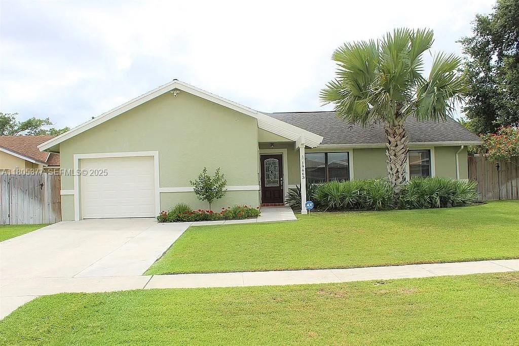 19663 Hampton Drive Boca Raton, FL 33434 - Photo 30 of 33 a view of a house with a yard and potted plants