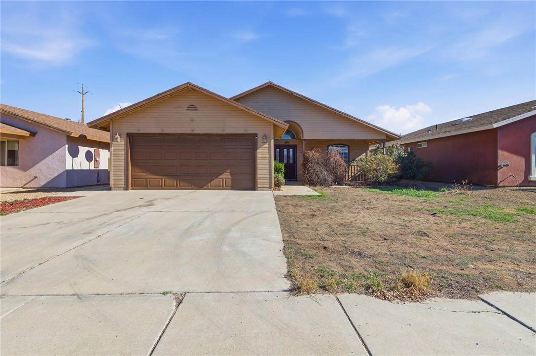 3740 North Kenneth Road Kingman, AZ 86409 - Photo 1 of 26 Ranch-style house featuring concrete driveway and an attached garage