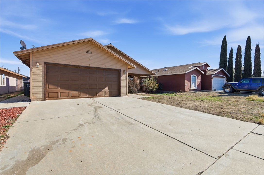 3740 North Kenneth Road Kingman, AZ 86409 - Photo 15 of 26 Ranch-style house with concrete driveway, an outdoor structure, and a garage