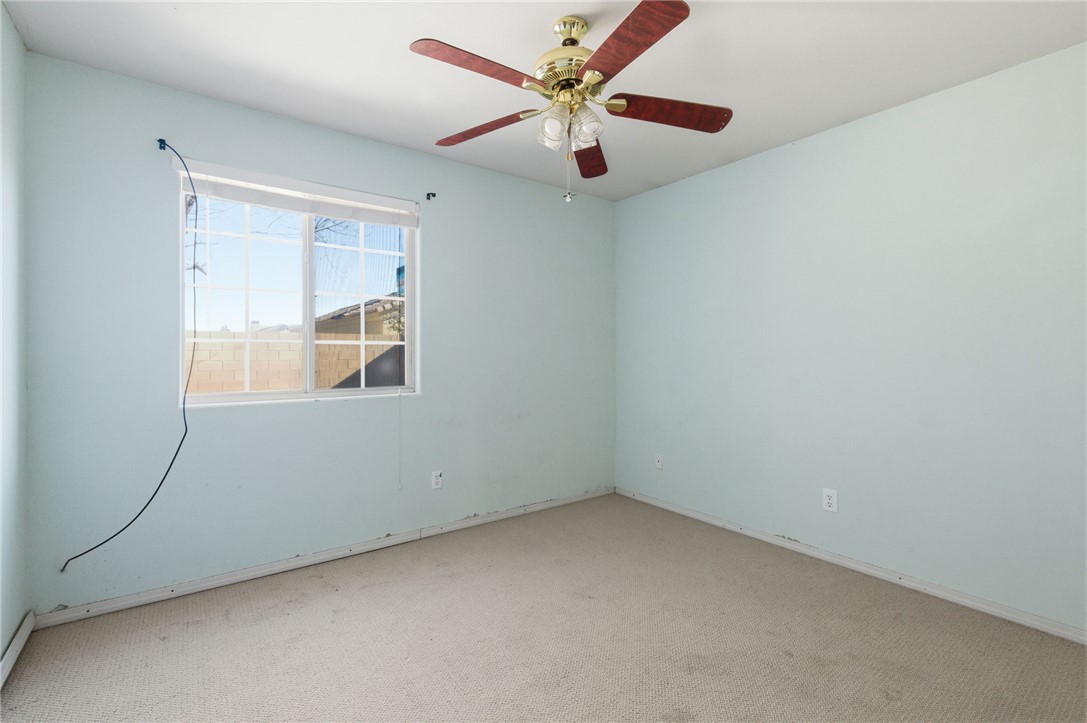3740 North Kenneth Road Kingman, AZ 86409 - Photo 18 of 26 Unfurnished room featuring carpet and a ceiling fan