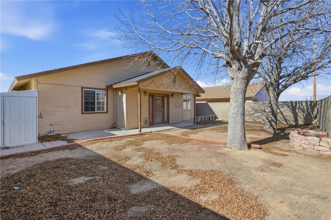 3740 North Kenneth Road Kingman, AZ 86409 - Photo 23 of 26 Rear view of house featuring a fenced backyard