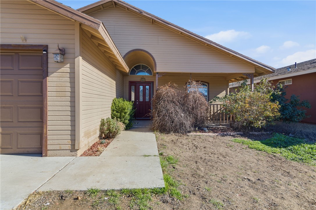 3740 North Kenneth Road Kingman, AZ 86409 - Photo 25 of 26 Doorway to property with covered porch and an attached garage
