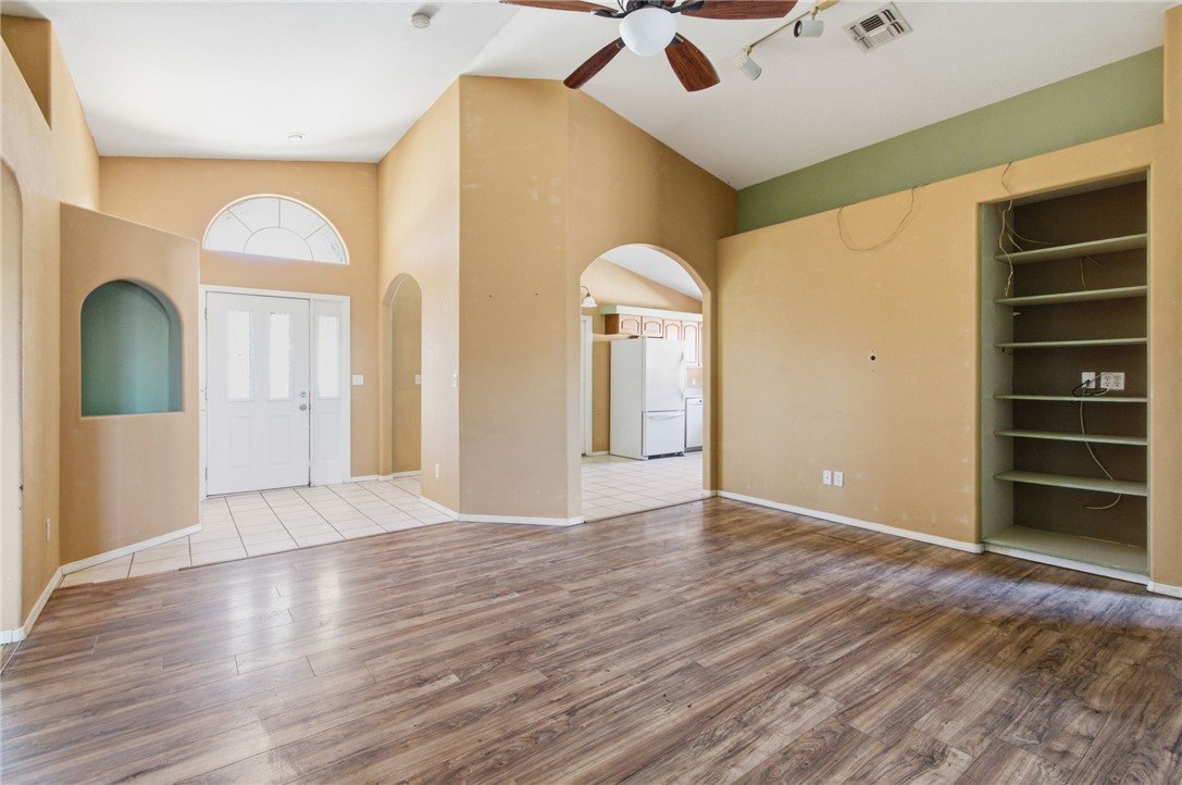 3740 North Kenneth Road Kingman, AZ 86409 - Photo 5 of 26 Foyer featuring a ceiling fan, wood finished floors, arched walkways, and high vaulted ceiling