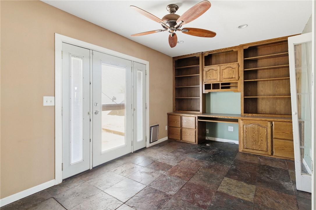 3740 North Kenneth Road Kingman, AZ 86409 - Photo 10 of 26 Unfurnished office with built in study area, ceiling fan, and stone tile floors