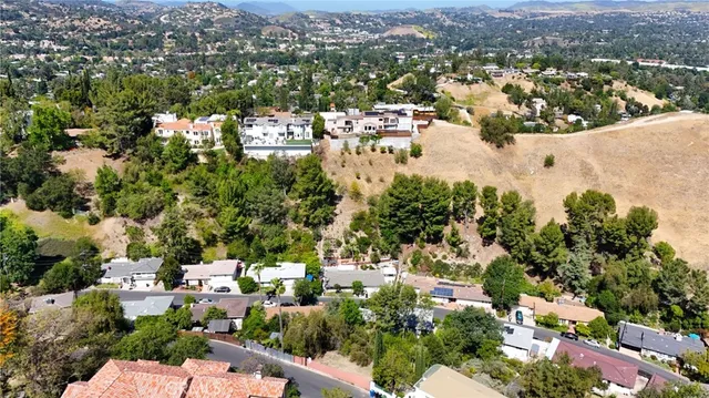 an aerial view of a house with a yard and a outdoor seating