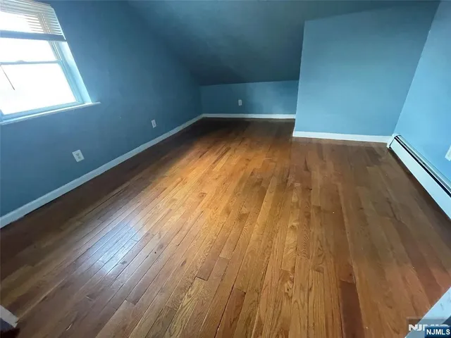 a view of a room with wooden floors and trees