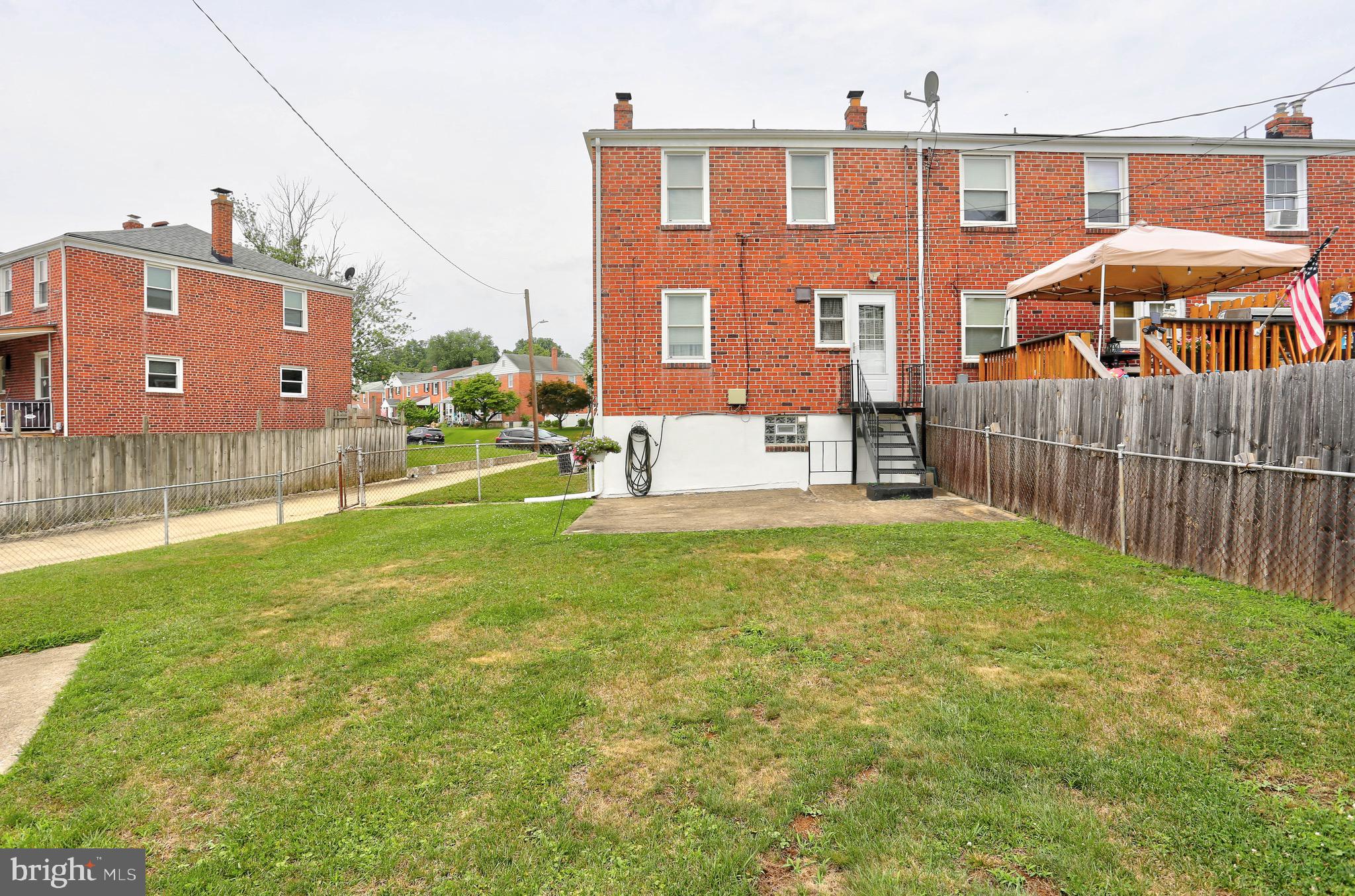 123 Garden Ridge Road Baltimore, MD 21228 - Photo 24 of 29 a view of backyard with table and chairs and wooden fence