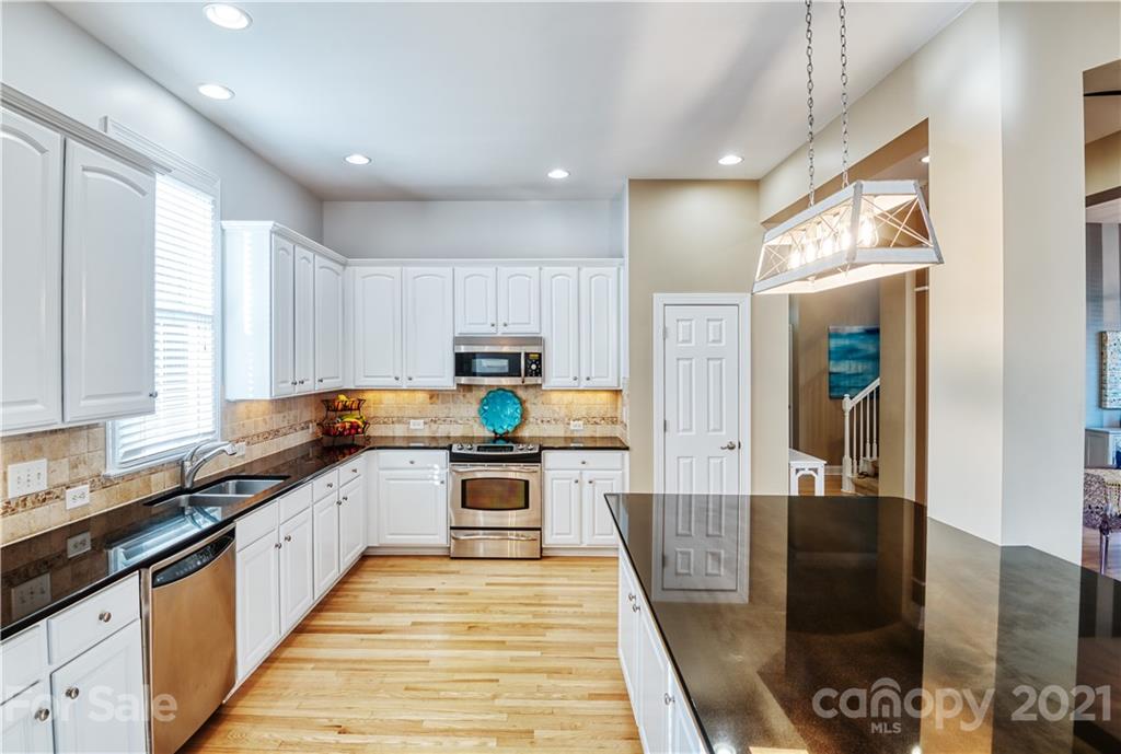 3349 Richard's Crossing Fort Mill, SC 29708 - Photo 12 of 33 a large kitchen with stainless steel appliances granite countertop a stove and a sink