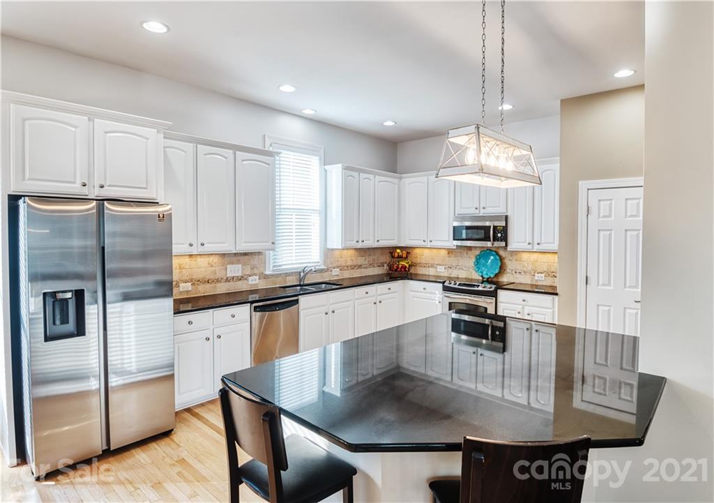 3349 Richard's Crossing Fort Mill, SC 29708 - Photo 13 of 33 a kitchen with stainless steel appliances granite countertop a sink a stove and a refrigerator