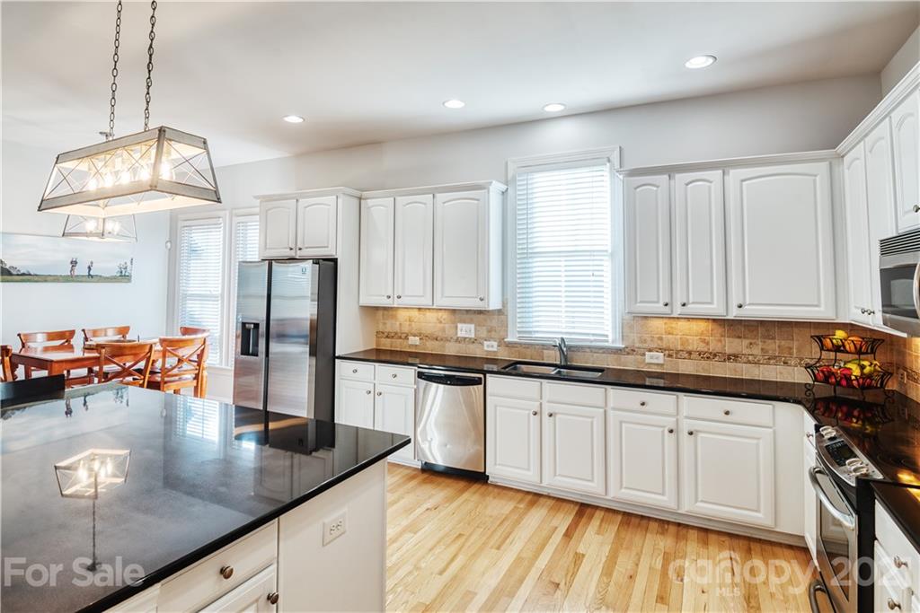 3349 Richard's Crossing Fort Mill, SC 29708 - Photo 14 of 33 a kitchen with stainless steel appliances granite countertop a sink a stove and refrigerator