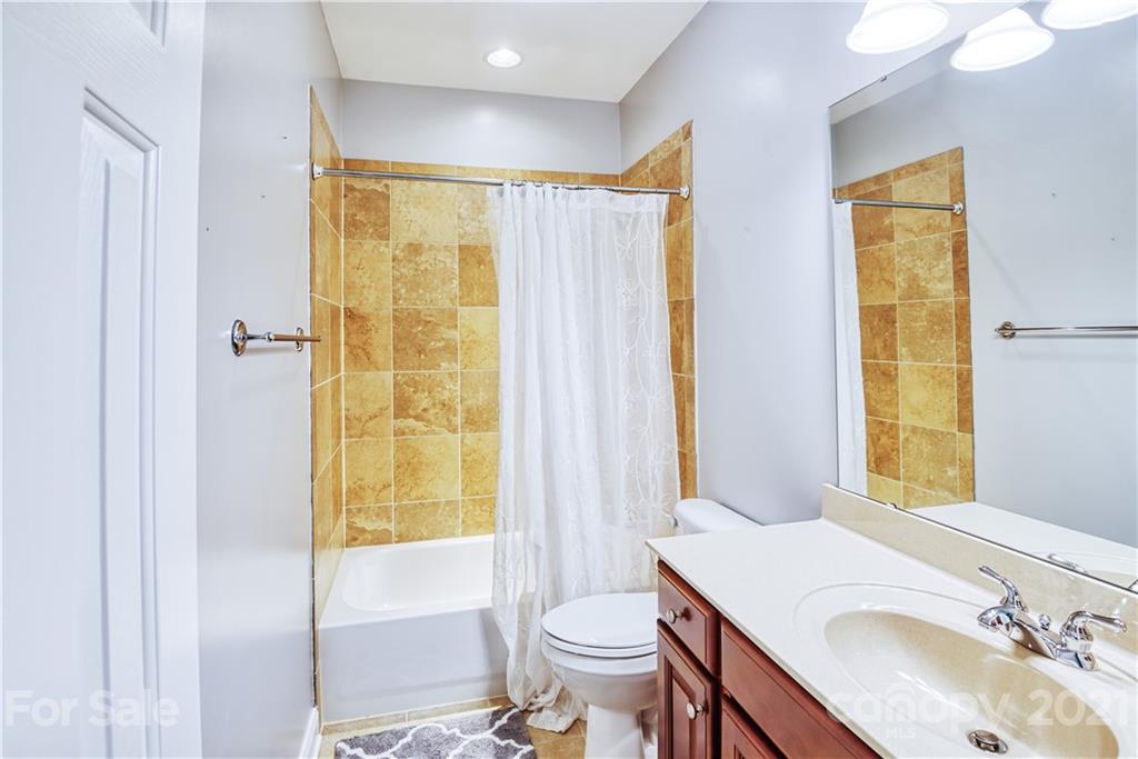 3349 Richard's Crossing Fort Mill, SC 29708 - Photo 20 of 33 a bathroom with a granite countertop sink toilet and shower