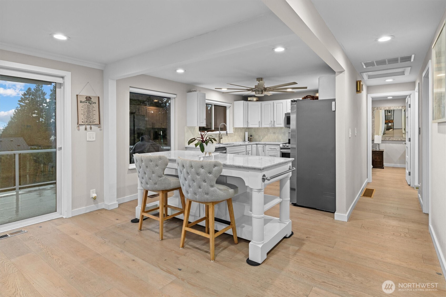 3415 Garden Avenue North Renton, WA 98056 - Photo 12 of 34 a dining hall with stainless steel appliances kitchen island granite countertop a refrigerator and a sink