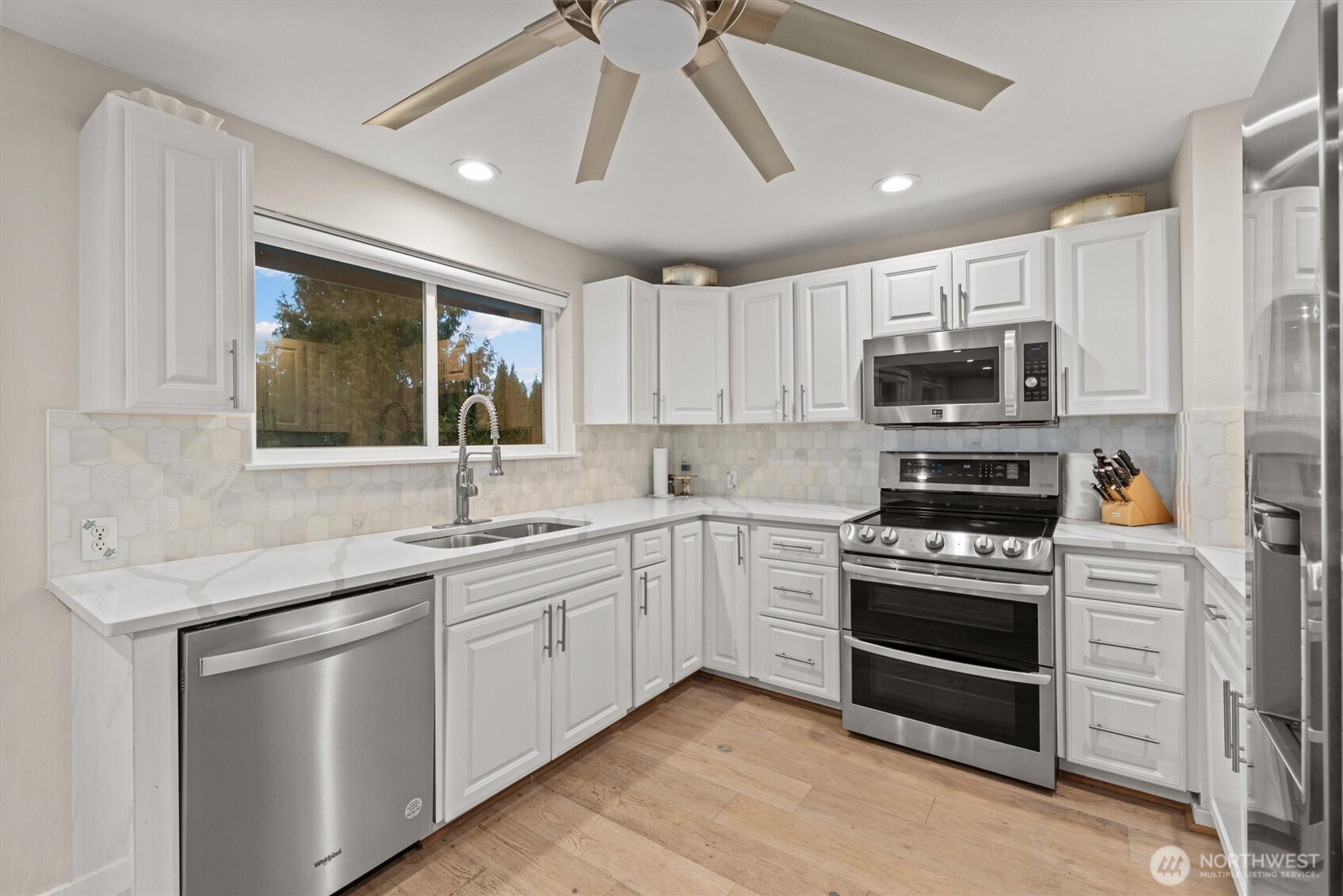 3415 Garden Avenue North Renton, WA 98056 - Photo 13 of 34 a kitchen with stainless steel appliances a stove sink microwave and refrigerator