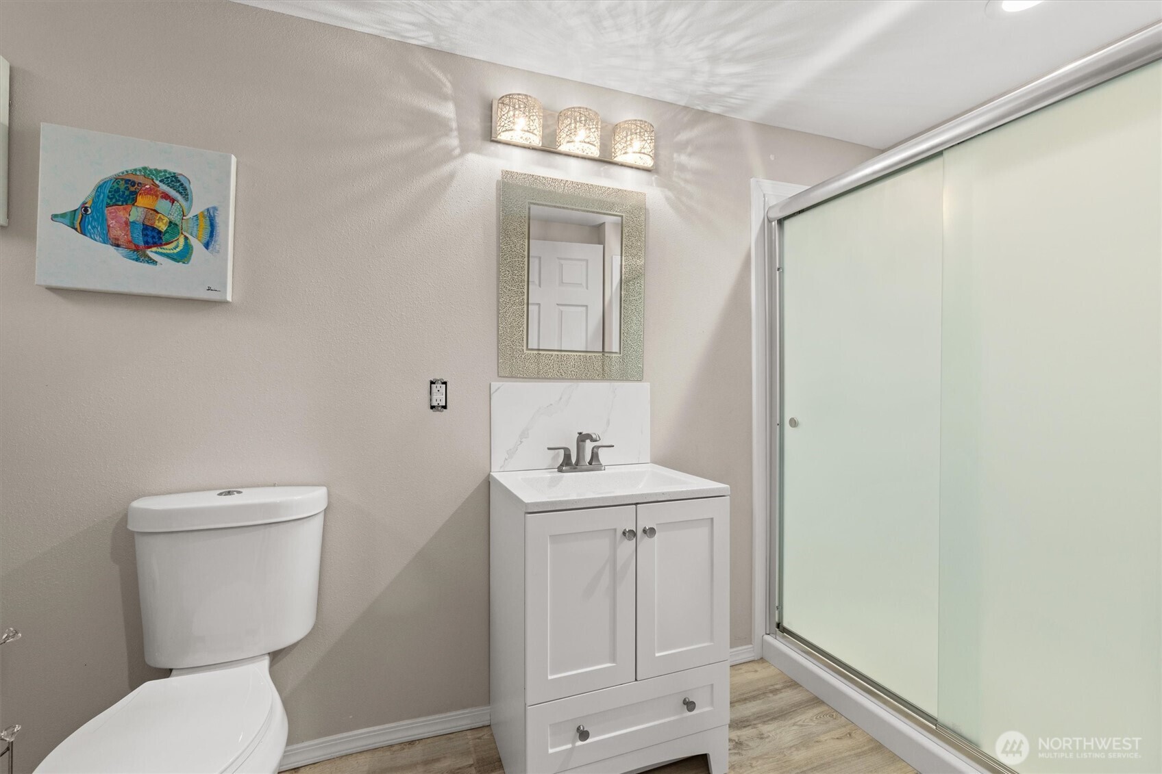 3415 Garden Avenue North Renton, WA 98056 - Photo 27 of 34 a bathroom with a toilet a sink and mirror
