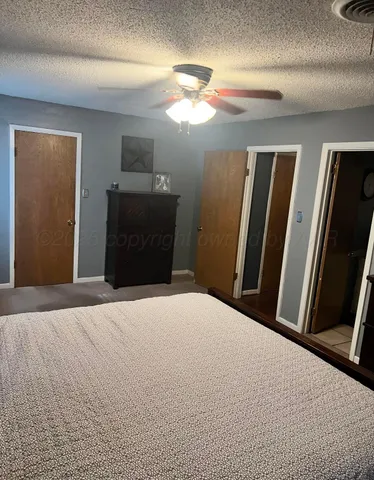 a bedroom with a bed and a mirror