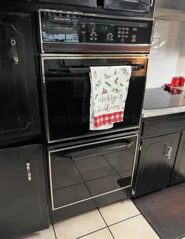 a stove top oven sitting inside of a kitchen