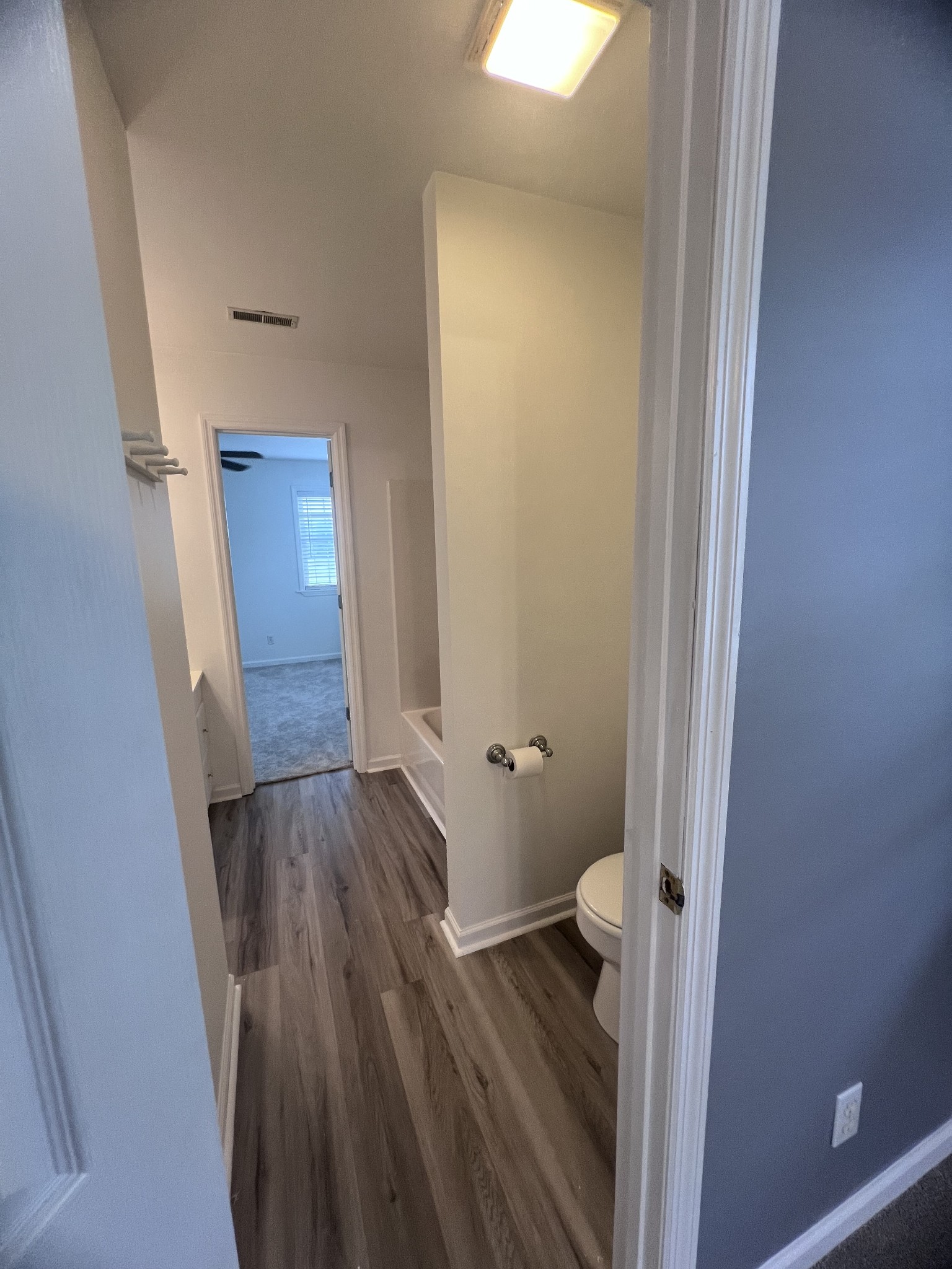 2668 Ragsdale Road Manchester, TN 37355 - Photo 29 of 32 a view of a hallway with wooden floor and a bathroom