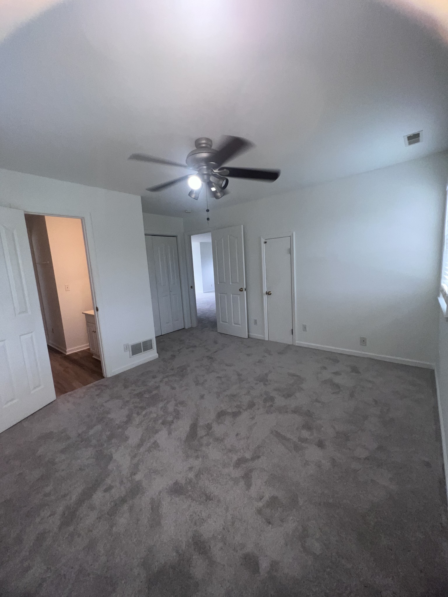2668 Ragsdale Road Manchester, TN 37355 - Photo 31 of 32 an empty room with a ceiling fan and hardwood floor