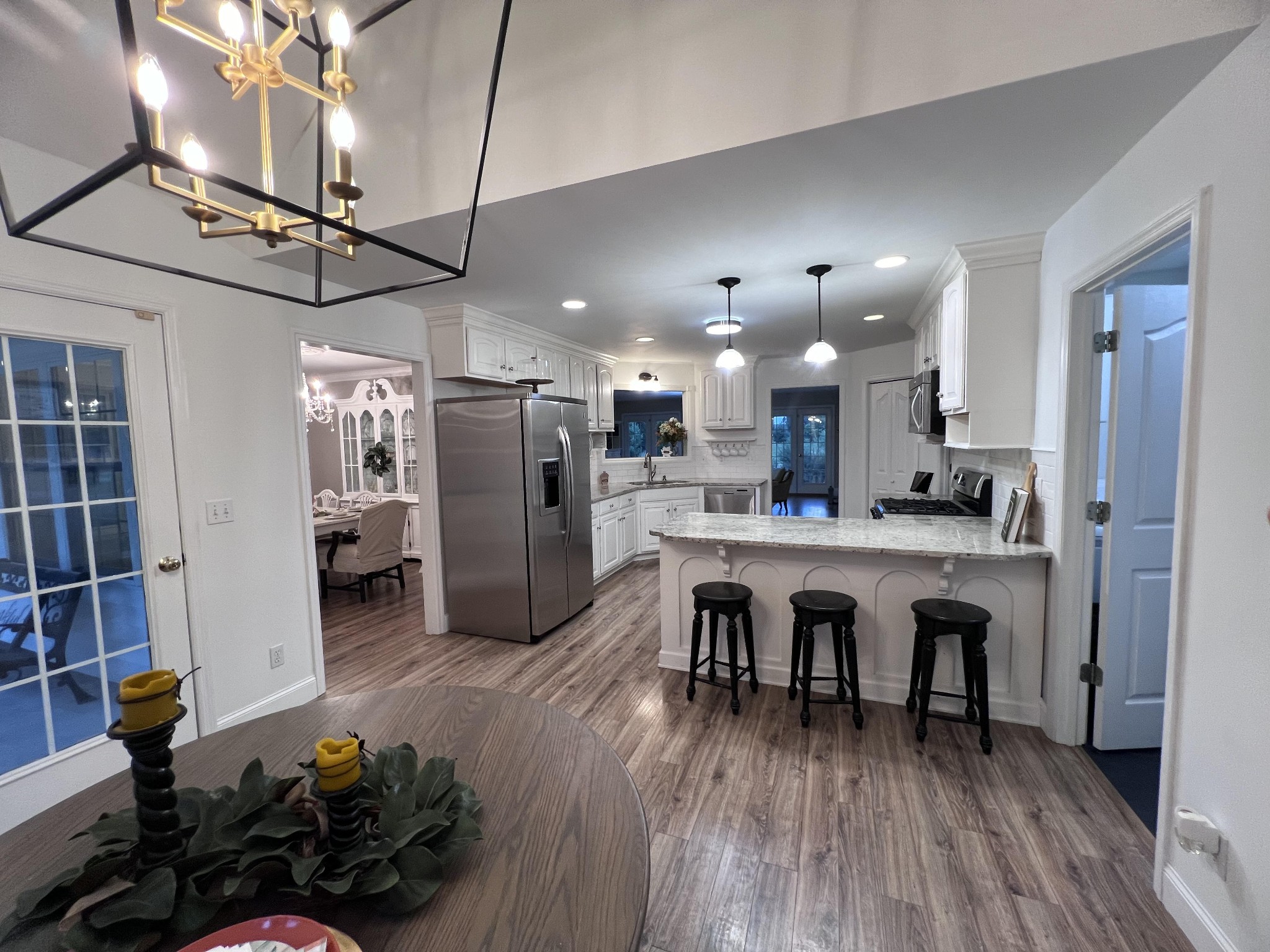 2668 Ragsdale Road Manchester, TN 37355 - Photo 6 of 32 a kitchen with stainless steel appliances granite countertop a refrigerator a oven a sink and white cabinets with wooden floor