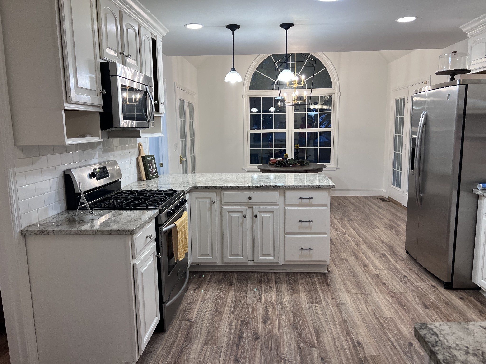 2668 Ragsdale Road Manchester, TN 37355 - Photo 7 of 32 a kitchen with stainless steel appliances granite countertop a stove a sink dishwasher a refrigerator and a wooden floor