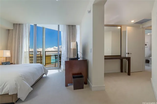 a spacious bedroom with a bed and a couch