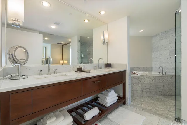 a bathroom with a double vanity sink mirror and shower