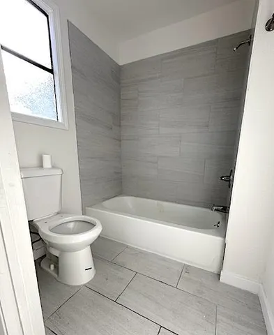 a bathroom with a bathtub and toilet