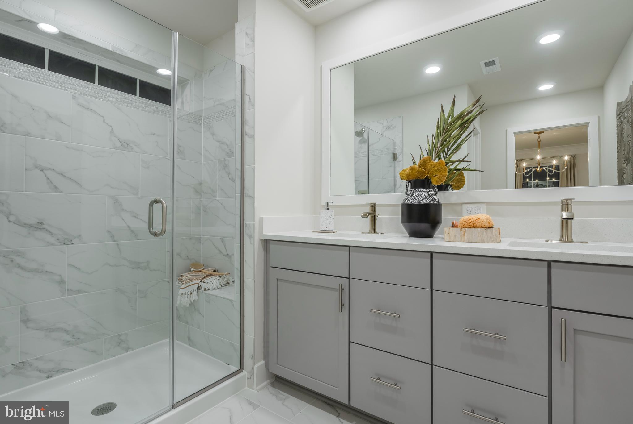 7708 Johnnycake Road Windsor Mill, MD 21244 - Photo 12 of 18 a bathroom with a sink mirror and shower