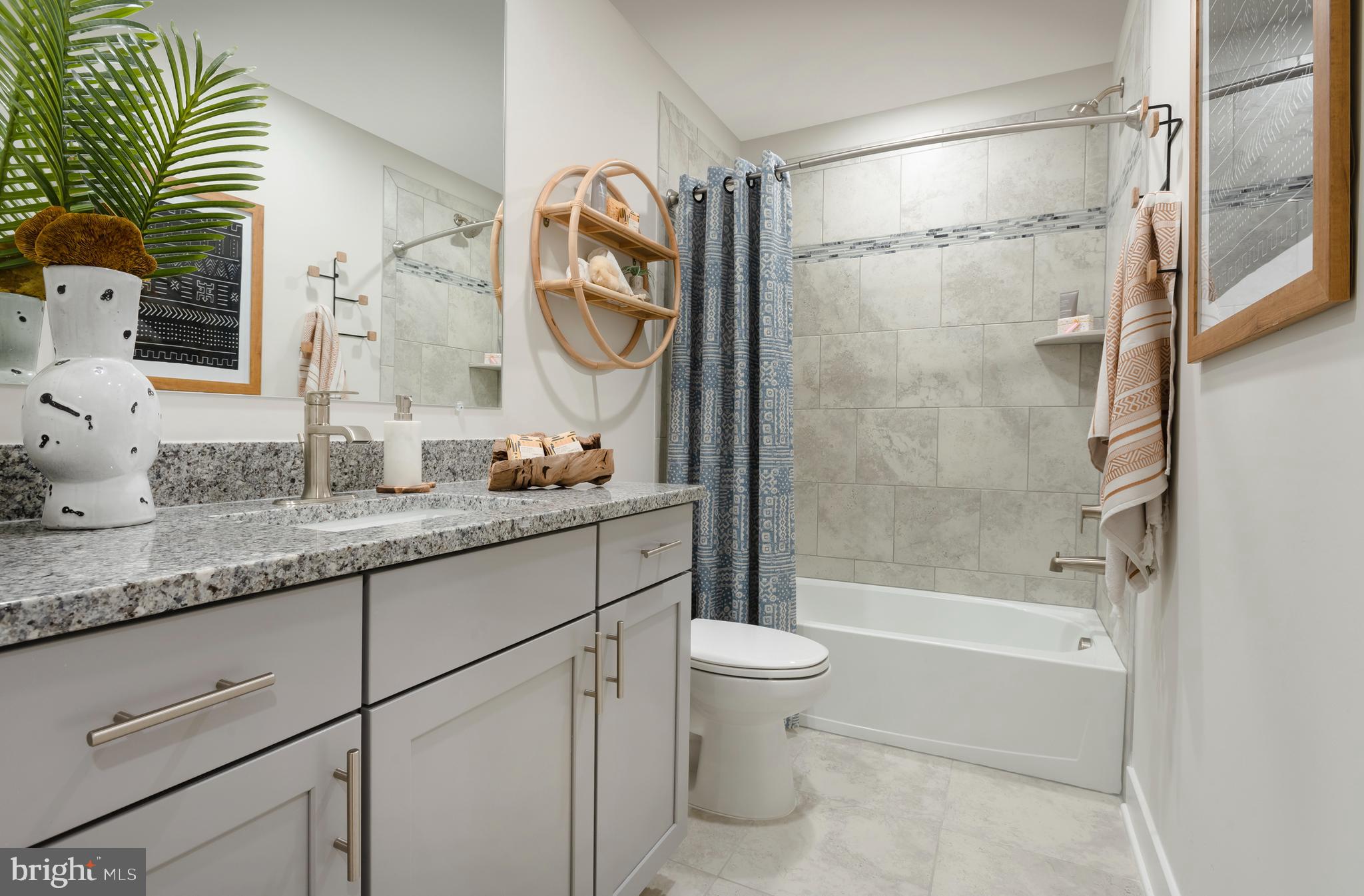 7708 Johnnycake Road Windsor Mill, MD 21244 - Photo 17 of 18 a bathroom with a granite countertop sink a toilet and shower