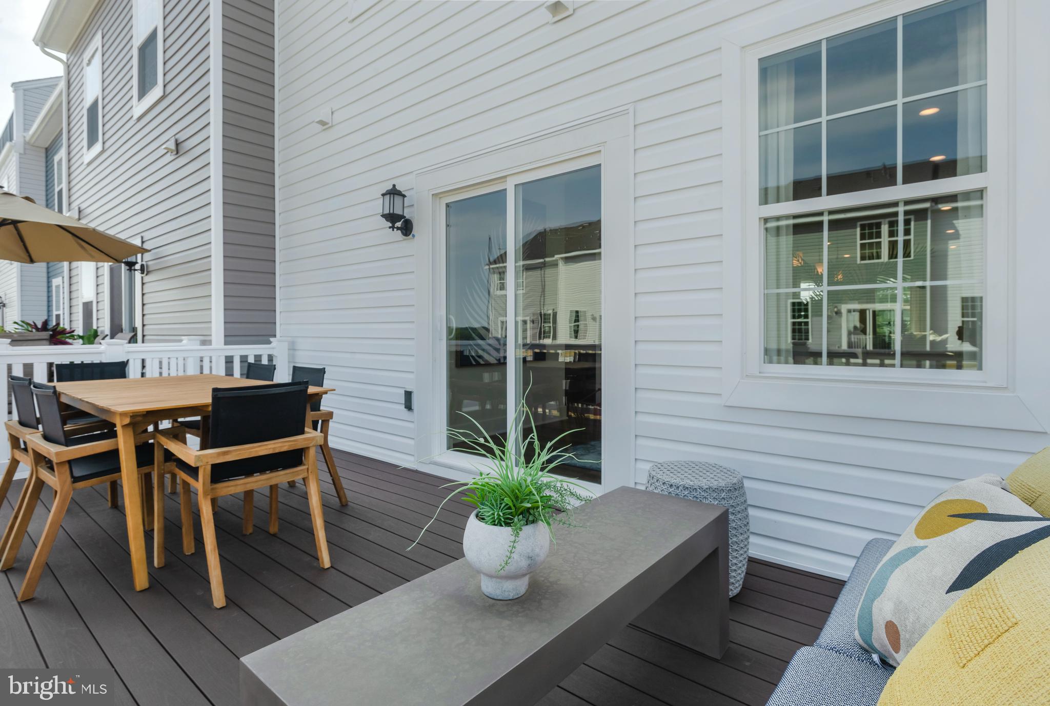 7708 Johnnycake Road Windsor Mill, MD 21244 - Photo 18 of 18 a view of a deck with table and chairs potted plants with wooden floor