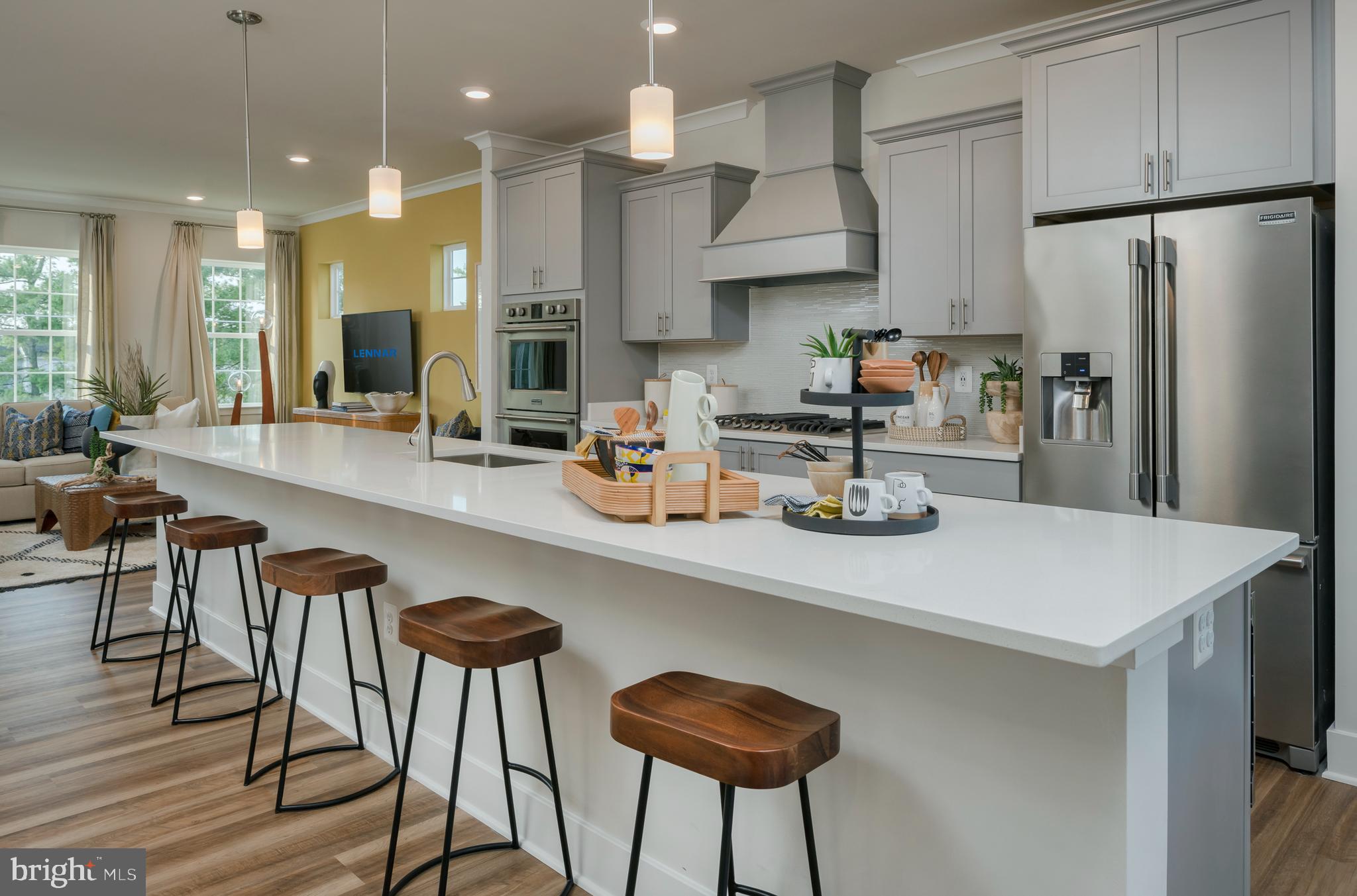 7708 Johnnycake Road Windsor Mill, MD 21244 - Photo 2 of 18 a kitchen with stainless steel appliances a dining table chairs and a refrigerator