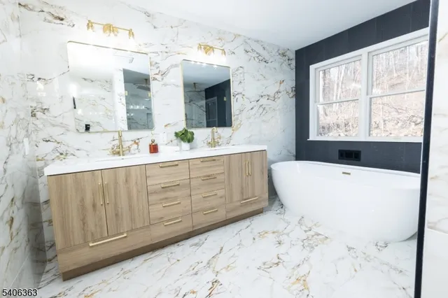 a spacious bathroom with a bathtub sink and mirror