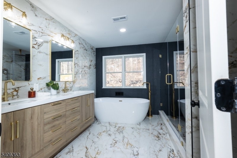 13 Sycamore Way Warren, NJ 07059 - Photo 22 of 50 a spacious bathroom with a bathtub sink and mirror
