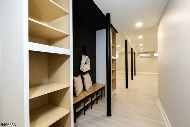 a view of hallway with stairs and wooden floor