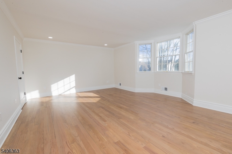 13 Sycamore Way Warren, NJ 07059 - Photo 29 of 50 a view of empty room with wooden floor and fan