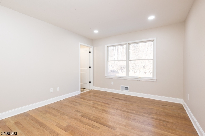 13 Sycamore Way Warren, NJ 07059 - Photo 30 of 50 a view of an empty room with wooden floor and a window