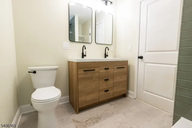 a bathroom with a toilet sink and mirror