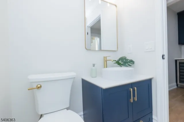 a bathroom with a sink a toilet and mirror