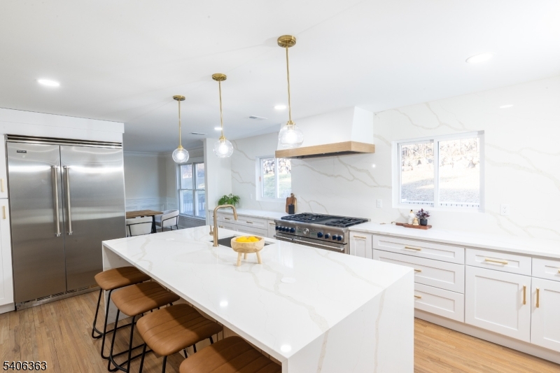 13 Sycamore Way Warren, NJ 07059 - Photo 4 of 50 a kitchen with stainless steel appliances a stove a sink a center island and wooden floor