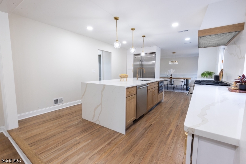 13 Sycamore Way Warren, NJ 07059 - Photo 46 of 50 a large kitchen with stainless steel appliances a large counter top a sink a refrigerator and a fireplace