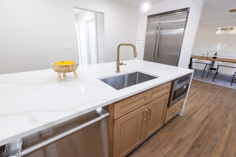 13 Sycamore Way Warren, NJ 07059 - Photo 48 of 50 a kitchen with stainless steel appliances granite countertop a sink a stove and wooden floors