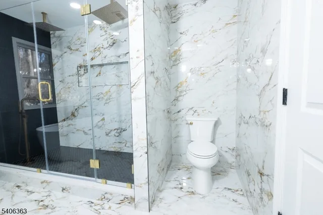 a bathroom with a toilet and a shower