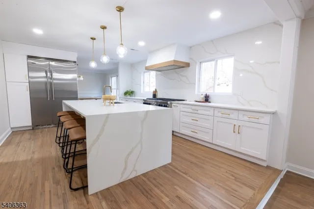 a kitchen with a sink a cabinets and wooden floor
