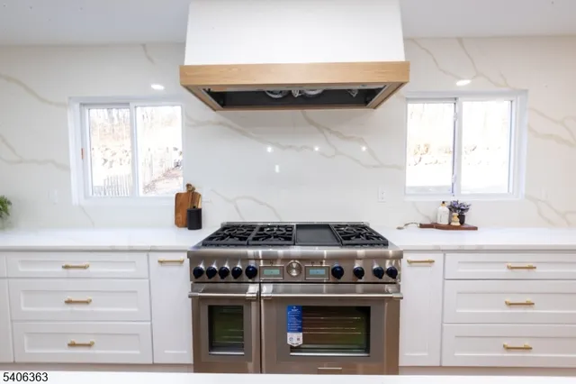 a stove top oven sitting inside of a kitchen