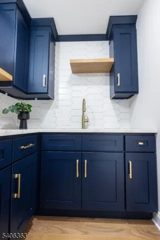 a kitchen with a sink wooden cabinets and a granite counter top