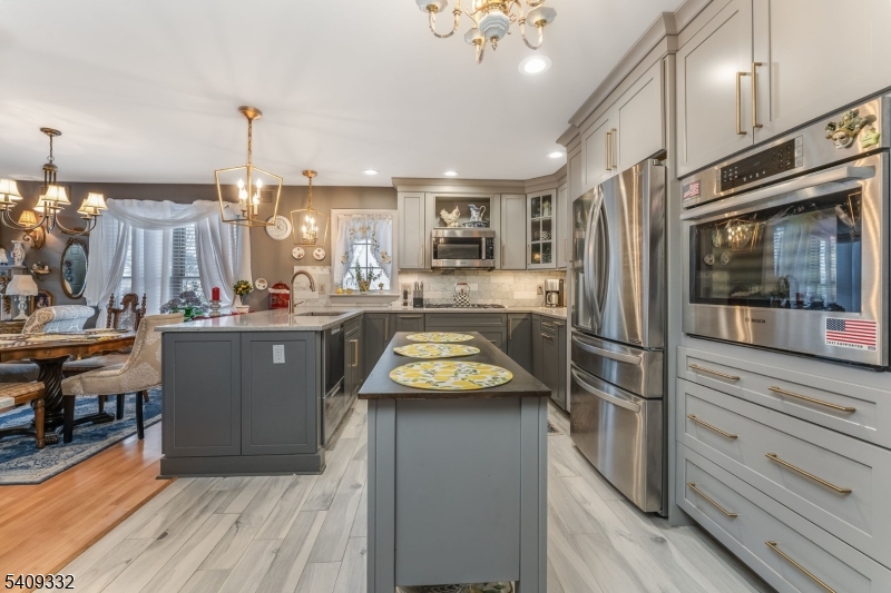 7 Rachel Court Clinton, NJ 08809 - Photo 14 of 42 a kitchen with kitchen island granite countertop stainless steel appliances and counter space