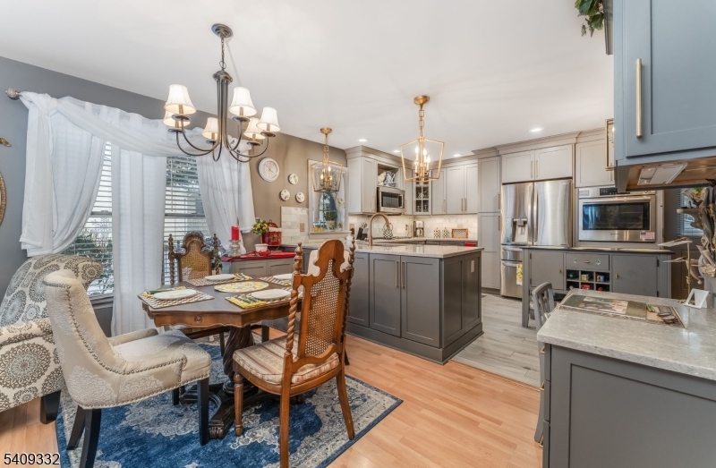 7 Rachel Court Clinton, NJ 08809 - Photo 15 of 42 a view of a dining room with furniture a chandelier and wooden floor