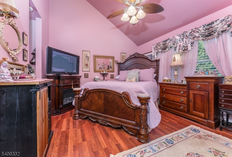 7 Rachel Court Clinton, NJ 08809 - Photo 21 of 42 a bedroom with a bed and wooden floor